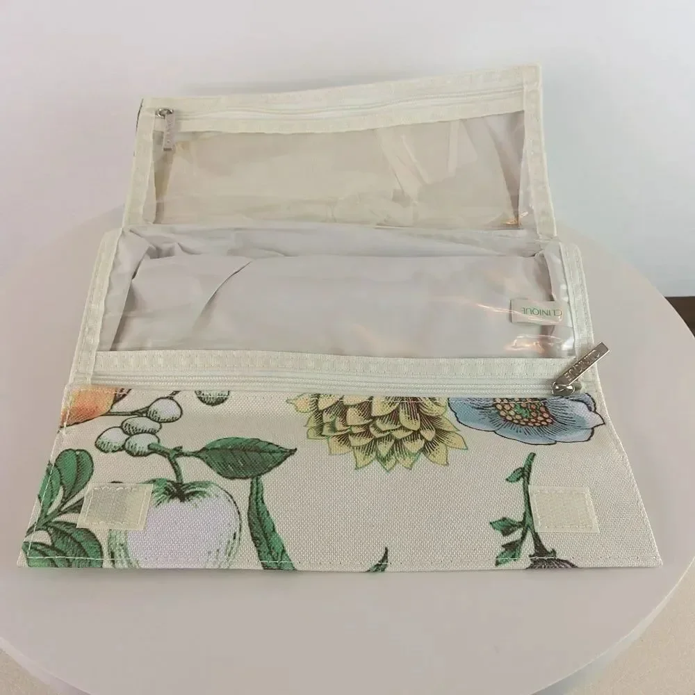 Clinique cream floral print fold over makeup / jewelry bag.